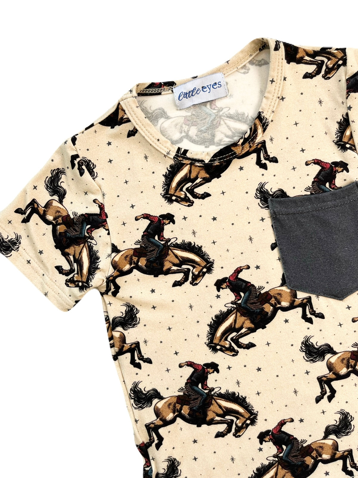 A boys bamboo drawstring shorts and pocket t-shirt set with a rodeo bonc riding print. Shorts are a dark gray colour with a white drawstring.